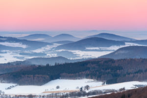 Low mountain landscape at dusk in winter, Milseburg, Danzwiesen, Rhoen Mountain, Hesse, Germany Low mountain landscape at dusk in winter, Milseburg, Danzwiesen, Rhoen Mountain, Hesse, Germany